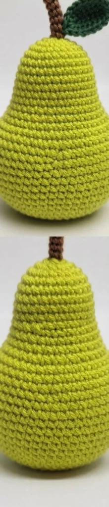 Close-up of a finished yellow-green crocheted pear amigurumi with brown stem, shown from two angles, with a green leaf visible in one view